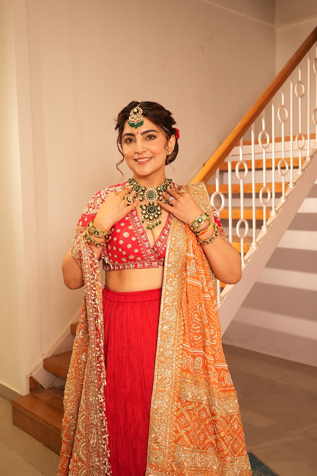 Ankita Kochar In Ruby Red Crush Lehenga with Orange Bandhani Dupatta