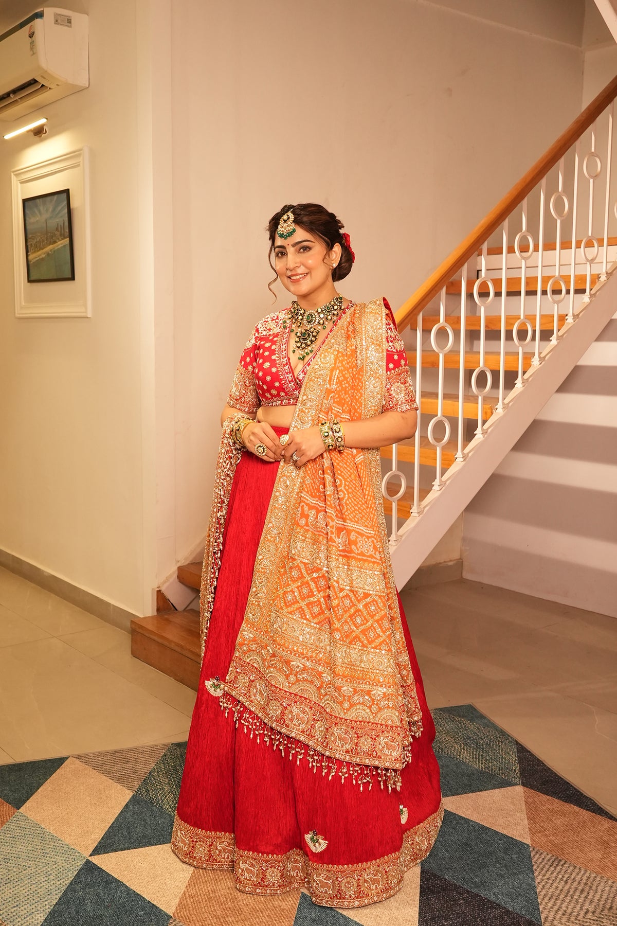 Ankita Kochar In Ruby Red Crush Lehenga with Orange Bandhani Dupatta