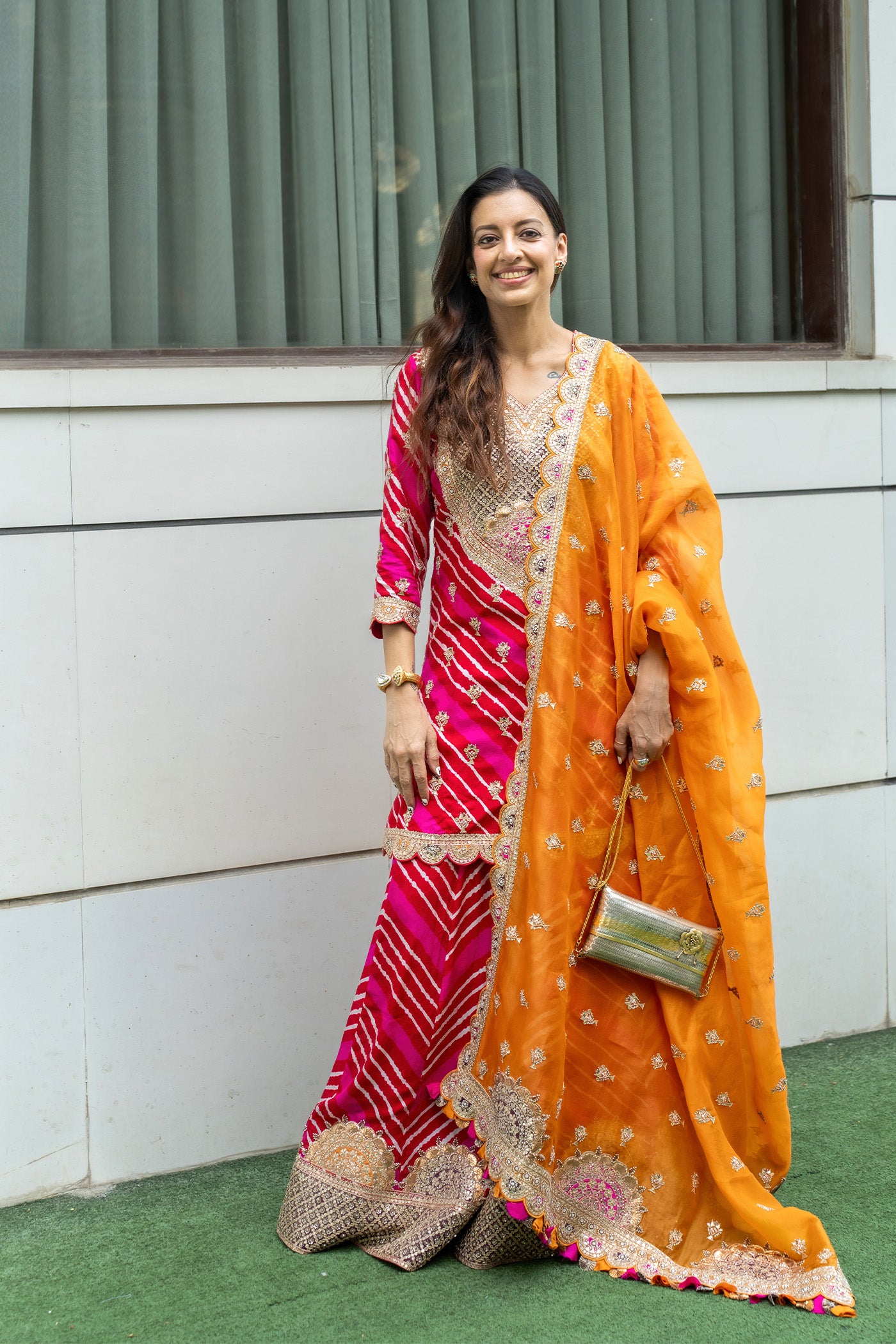 SHWETA MALPANI IN RED AND PINK LEHRIYA SHARARA KURTA SET WITH AN ORANGE ORGANZA DUPATTA