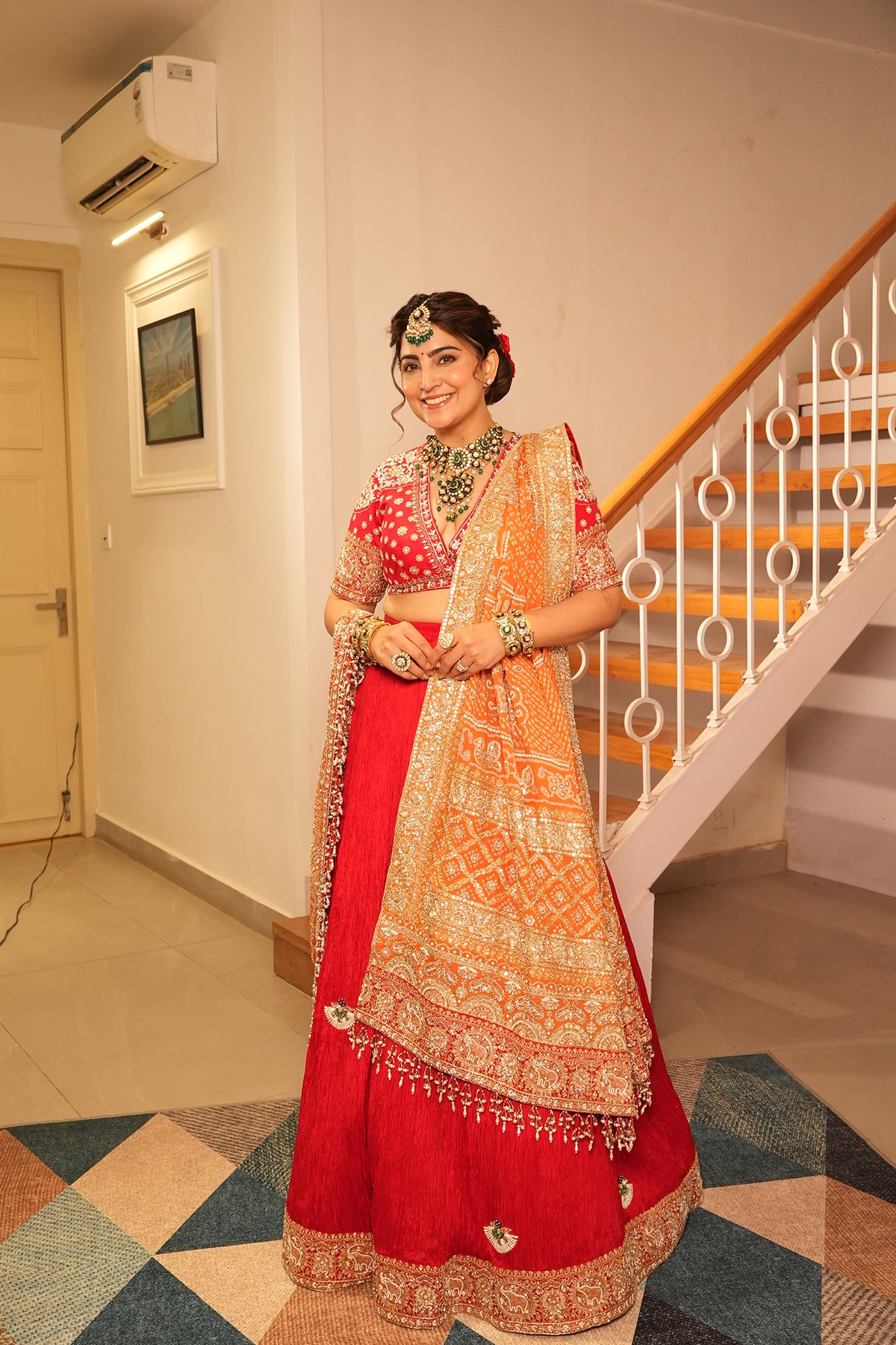 Ankita Kochar In Ruby Red Crush Lehenga with Orange Bandhani Dupatta