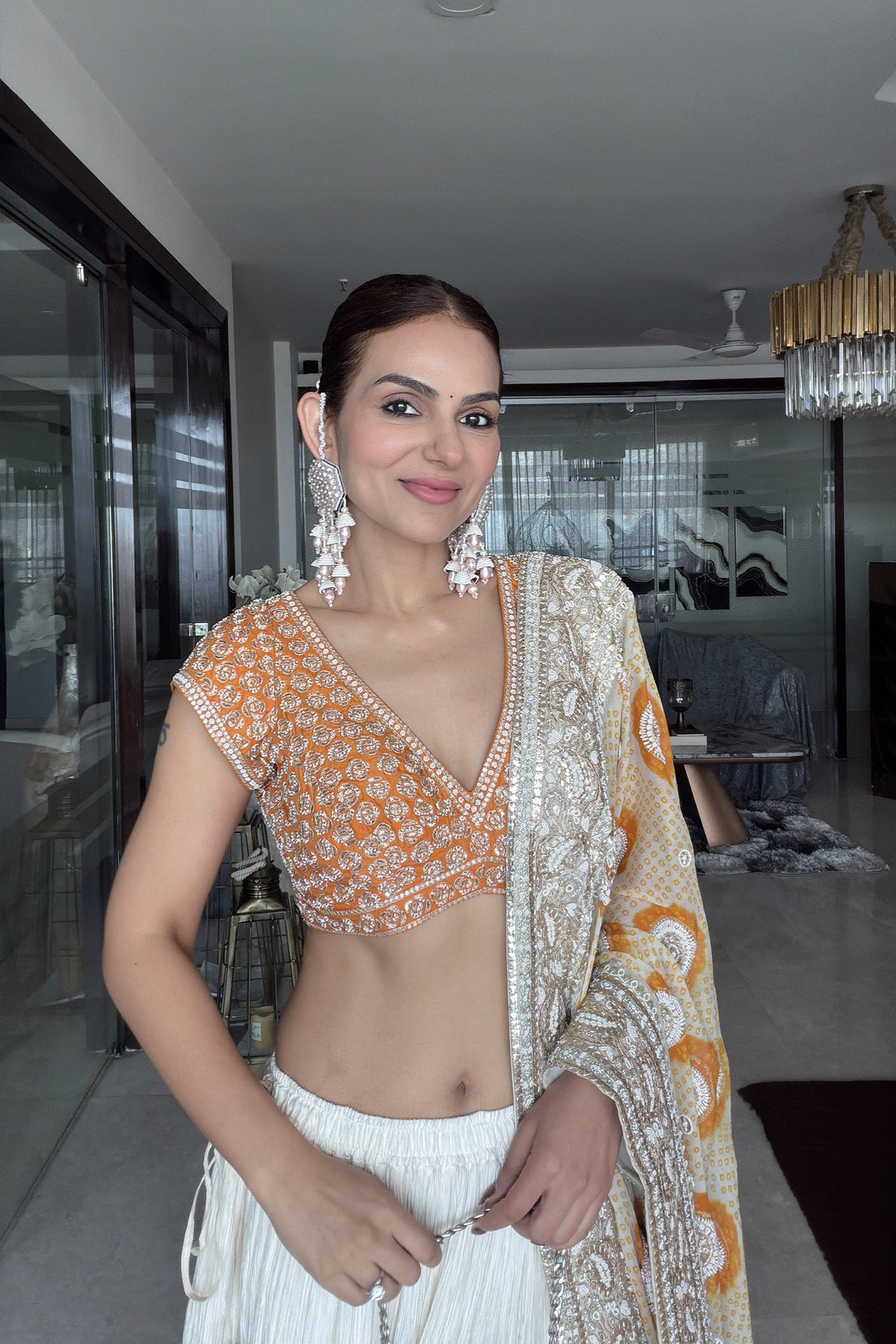 GAURI MEHTA In ivory crush lehenga set with ivory orange bandhani dupatta